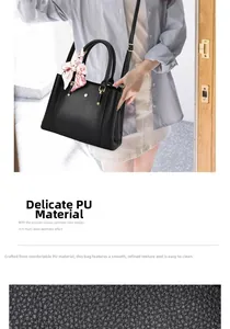 Detail of black lychee-textured PU leather handbag featuring a decorative floral silk scarf