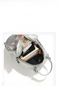 Top view of silver quilted backpack showing large capacity and internal compartments