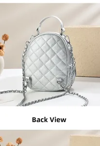 Detailed back view of a silver quilted backpack featuring metallic chain straps and D-rings