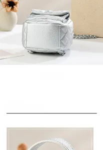 Detail of silver quilted mini backpack featuring metallic finish and chain strap