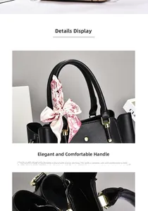Detail of black lychee leather handbag with floral silk scarf and gold hardware accents