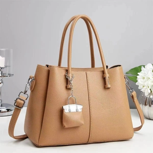 Brown litchi grain leather tote bag with shoulder strap and mini bag charm