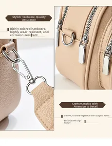 Detail view of beige lychee leather bag with silver zippers and edge painting