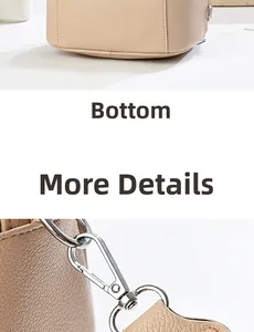 Close-up of leather texture, bottom stitching and silver metal hook on beige handbag