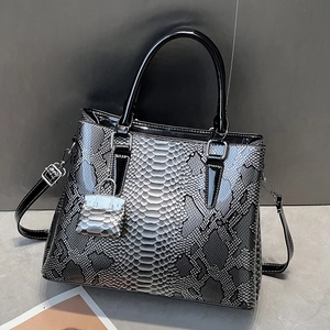 Chic silver and black snakeskin tote bag with top handle and matching mini pouch