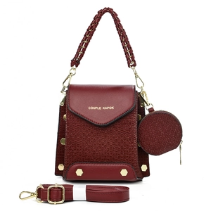 Structured burgundy square crossbody bag with woven handle and matching coin purse