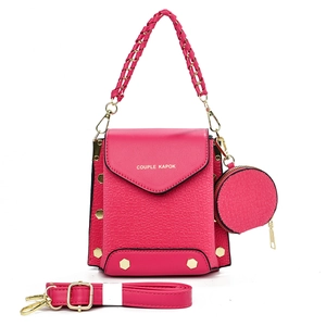 Detail of rose red crossbody bag set with embossed texture and small round purse