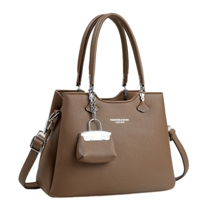 Dark brown pebbled leather handbag with top handles and adjustable shoulder strap