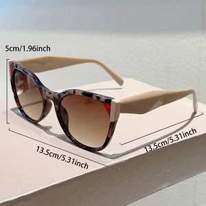 Detailed view of tortoiseshell sunglasses with pink temples and size measurements