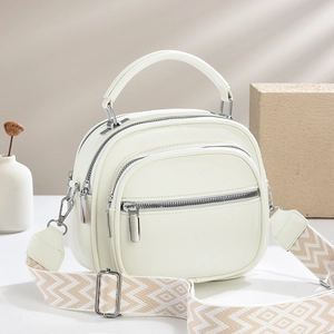 Chic cream textured leather handbag with geometric wide strap for elegant daily commute