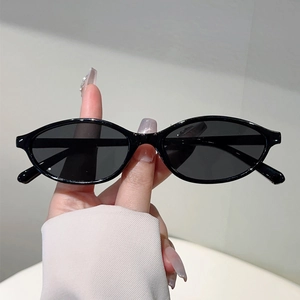Chic 2025 retro oval black sunglasses for women with a minimalist aesthetic and dark lenses
