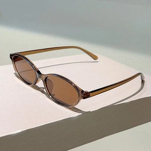 Detail of vintage oval tea lenses and translucent amber frames on trendy sunglasses