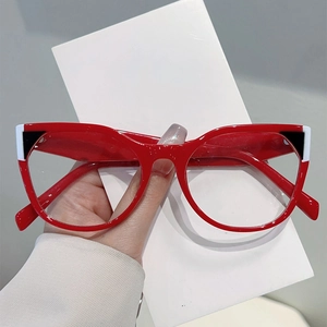 Modern red eyeglasses frame with black and white geometric details and clear anti-blue lenses