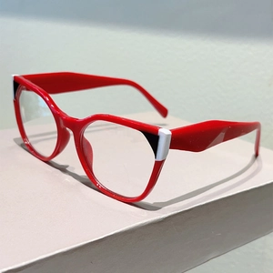 Detail of red cat-eye glasses frame with stylish black and white contrast accent