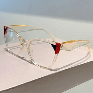 Detail of transparent eyeglasses frame featuring bold color-block accents and wavy temples