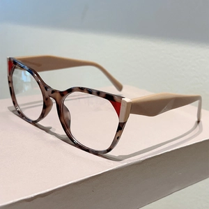 Detail view of retro cat-eye glasses frame with tortoiseshell and red color blocking