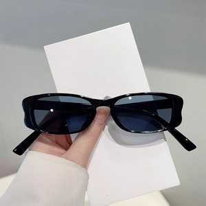 Retro small black frame sunglasses with dark lenses for trendy summer beach styling