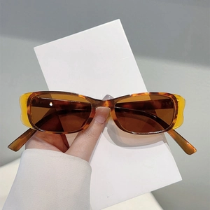 Close-up of retro tortoiseshell sunglasses with brown lenses and narrow oval frame