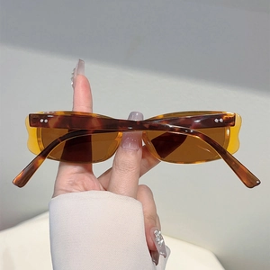 Close-up of retro small frame sunglasses featuring a classic brown tortoiseshell pattern