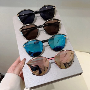 Detail of four colorful cat-eye sunglasses with metal frames and gradient lenses