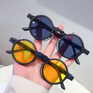 Detail view of round steampunk sunglasses with double-layered matte black frames