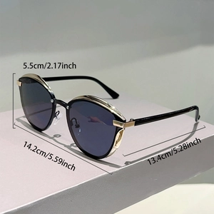 Detailed size specifications of cat eye sunglasses with gold accents on grey stand