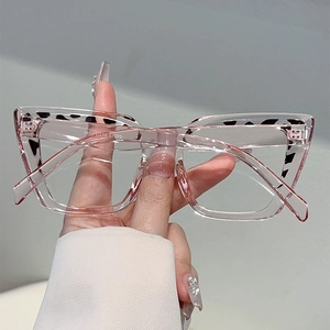 Detail of pink transparent square glasses with classic leopard print pattern on temples