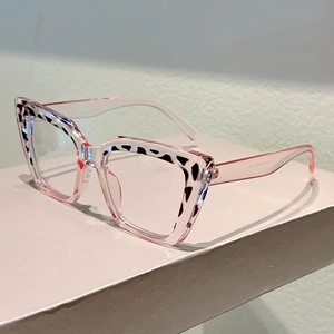 Detail of pink transparent cat-eye frame with black leopard print accent and sleek temples
