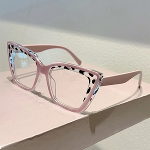 Detail of pink cat-eye glasses frame with leopard print upper rim on geometric stand