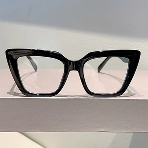 Detail of stylish black cat-eye frame glasses on a minimalist geometric display stand