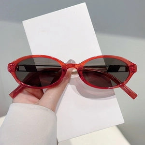 Vintage Y2K oval sunglasses with red translucent frame and dark grey lenses for fashion