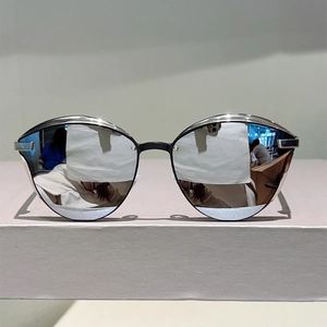 Detail view of cat eye sunglasses with black frames and silver mirrored lenses