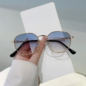 Minimalist polygon sunglasses with gold metal frame and blue gradient lenses for women