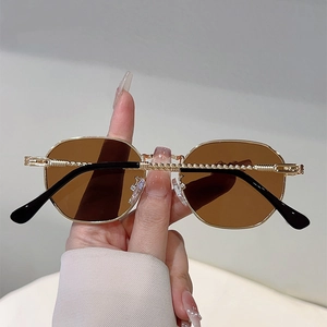 Detail of vintage gold metal frame sunglasses featuring unique twisted rope temple design