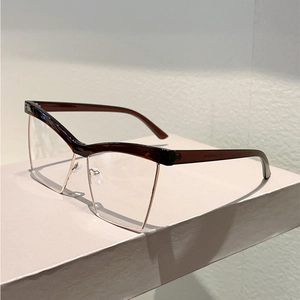 Detail view of cat-eye glasses with brown acetate frames and rose gold metal rims