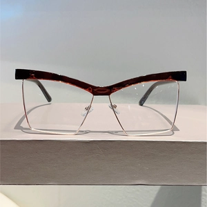 Detail of cat eye frame with tortoiseshell top and gold metal bottom rims