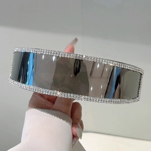 Close-up of luxury rimless sunglasses with hand-set rhinestones and futuristic dark lens