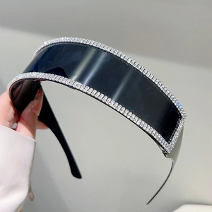 Detailed close-up of rimless oversized sunglasses with hand-set rhinestones and black lenses