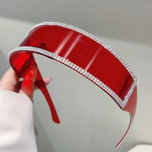 Close-up of futuristic red rimless sunglasses with double-row rhinestone embellishments