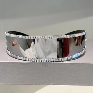Close-up of futuristic rimless sunglasses with silver mirrored lens and triple row rhinestones