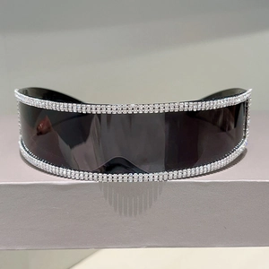Macro detail of futuristic rimless sunglasses featuring double-row rhinestone embellishments