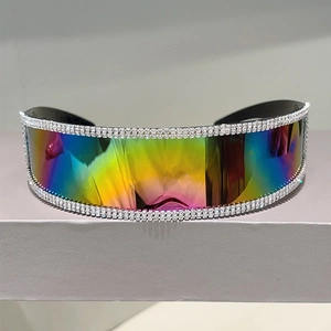 Close-up of futuristic rimless sunglasses featuring rainbow mirror lenses and rhinestone trim