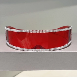 Detail of red frameless shield sunglasses with dense rows of sparkling rhinestones