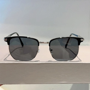 Detailed front view of retro semi-rimless sunglasses with silver metal frame and dark lenses
