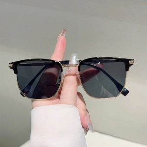 Retro half-frame Clubmaster sunglasses with black upper frame and gold metal accents