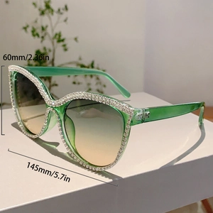Cat eye sunglasses detail showing 60mm height and 145mm width with rhinestone frames