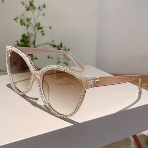 Close-up of cat-eye sunglasses with rhinestone-embellished translucent frames