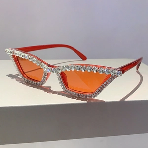 Détail de lunettes de soleil œil de chat rouges avec doubles rangées de strass brillants