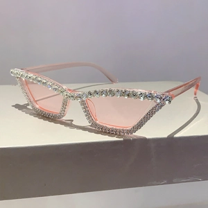 Vue détaillée des lunettes de soleil œil-de-chat roses avec strass blancs sertis à la main
