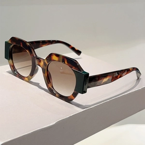 Close-up of tortoise shell sunglasses with geometric frames and gradient lenses